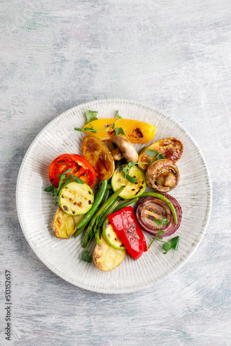 Grilled vegetables on a plate on a textured background