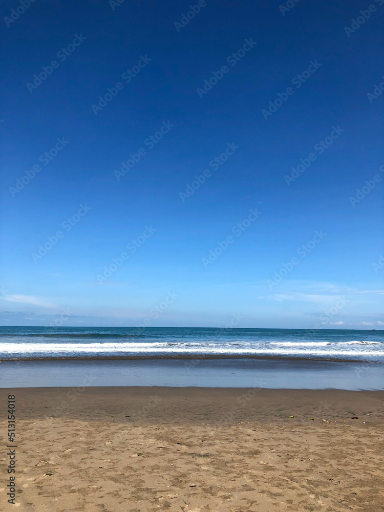 Sand beach in Bali with tropical sea and blue sky Sand beach in Bali with tropical sea and blue sky