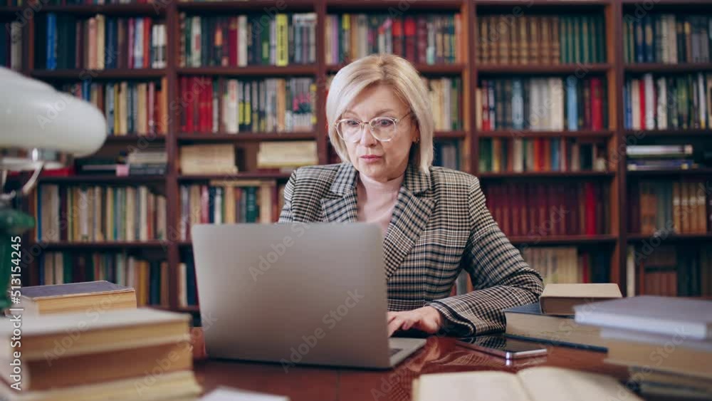 Disappointed woman in her 50s getting bad news on her laptop, confused lady Disappointed woman in her 50s getting bad news on her laptop, confused lady