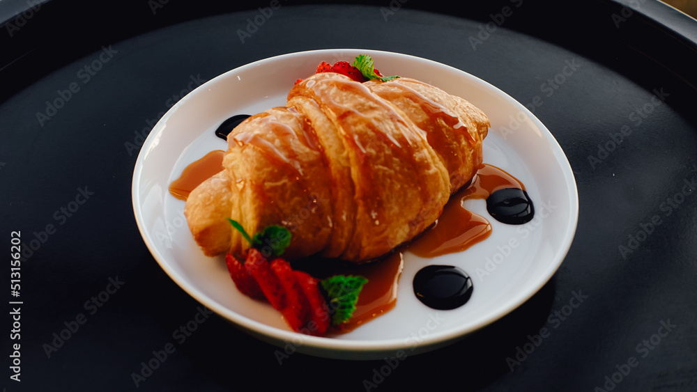 Croissant with cream and jam