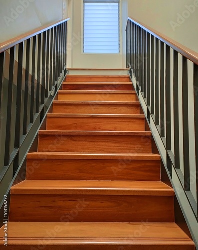Brown wooden stairs with iron railings. to walk up and down in the house