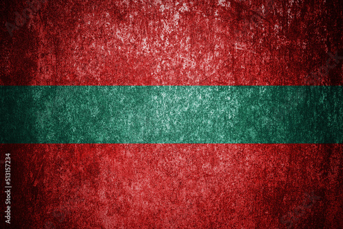 Closeup of grunge Transnistrian flag. Dirty Transnistria flag on a metal surface photo