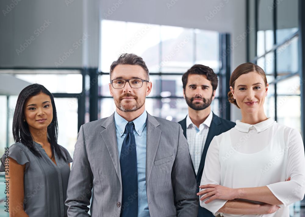 We are the benchmark. Cropped portrait of a group of businesspeople standing in the office. We are the benchmark. Cropped portrait of a group of businesspeople standing in the office.