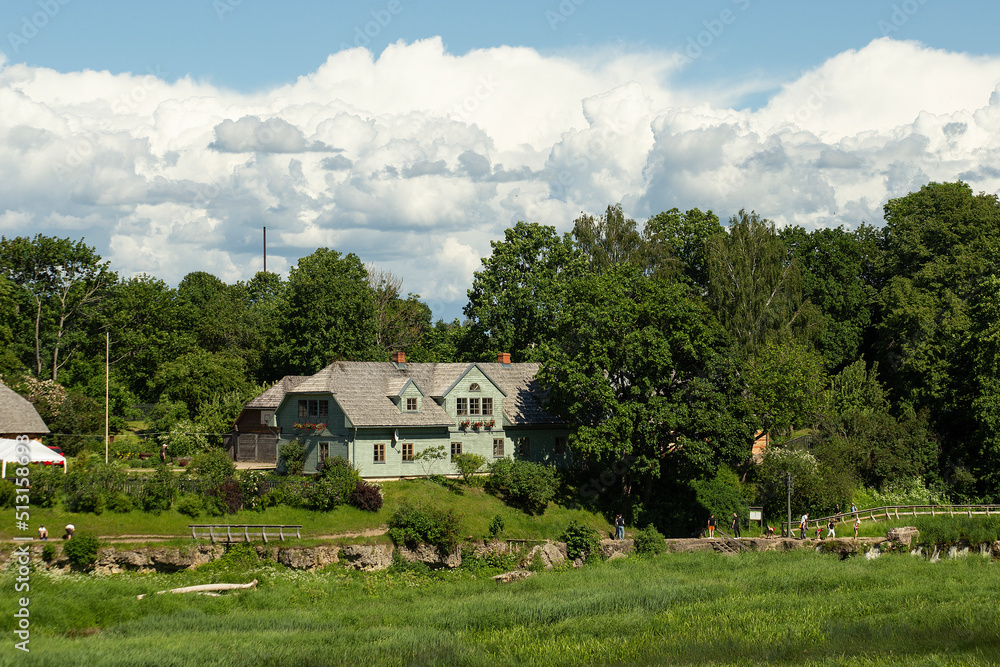 Beautiful landscape with an old house across the river, Kuldiga, Latvia. High quality photo