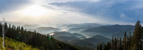 Panorama on cloudy weather over hills covered with spruce forests in Rhodope Mountains and fog between mountain ranges photo