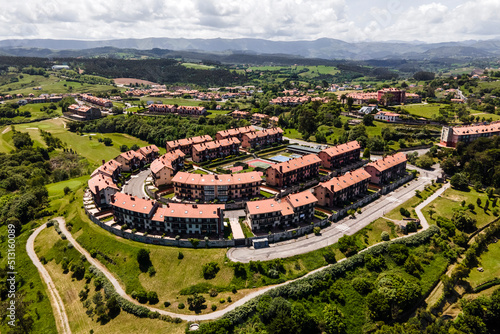 Fotografie, Obraz Aerial view of a residential district with houses on hilltop in Comillas, Cantabria, Spain