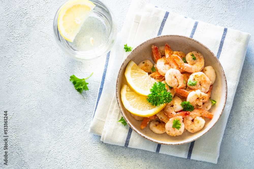 Frying shrimps with lemon in the bawl.