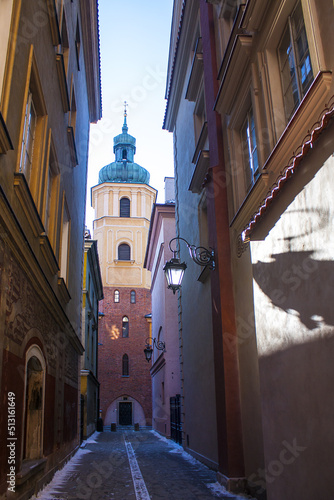  Narrow street and St. Martin church bell tower in Warsaw Old Town, Poland photo