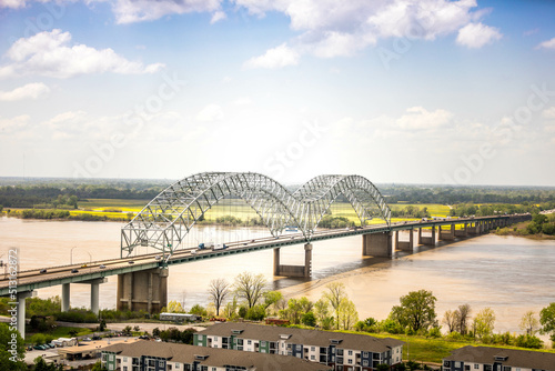 Beautiful shot of the design of Hernando de Soto Memphis bridge over a river and green landscape photo