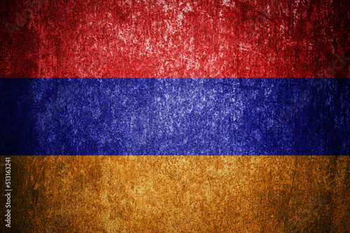 Closeup of grunge Armenian flag. Dirty Armenia flag on a metal surface