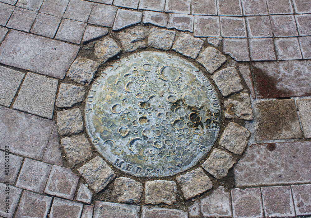 Bronze Mercury on the ground near the monument to Nicholas Copernicus