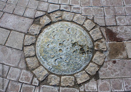 Bronze Mercury on the ground near the monument to Nicholas Copernicus