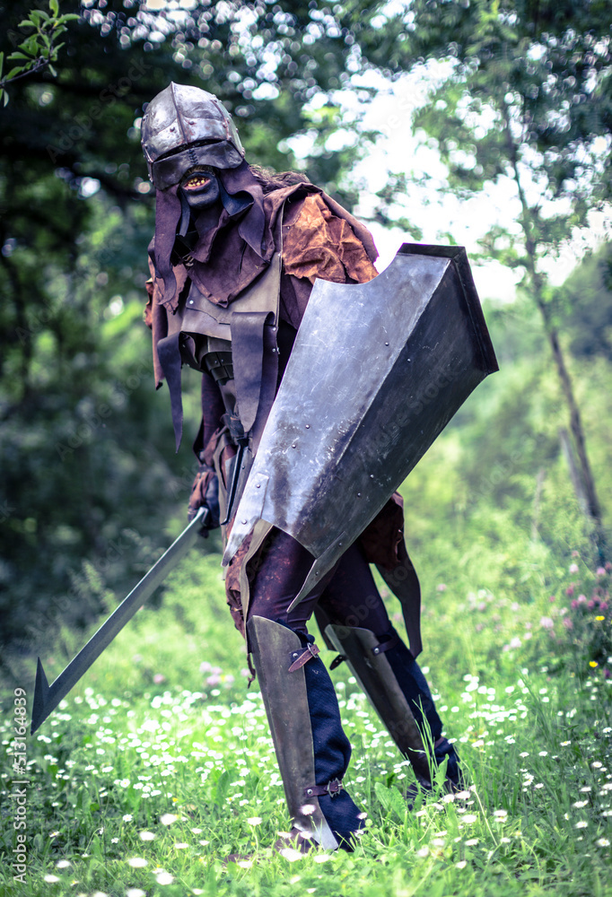 Uruk-hai warrior with helmet and sword from the lord of the rings Stock  Photo | Adobe Stock