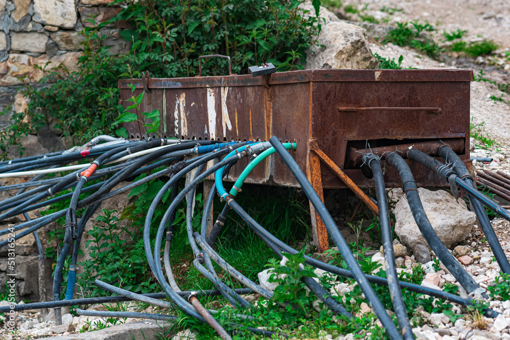 makeshift plumbing in a mountain village: water from a spring enters the tank through a pipe and is distributed to houses using hoses makeshift plumbing in a mountain village: water from a spring enters the tank through a pipe and is distributed to houses using hoses