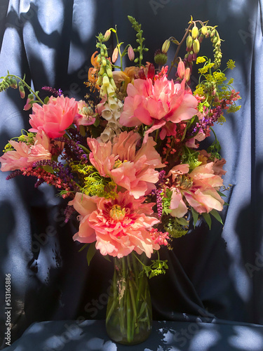 Romantic bouquets of spring flowers with peonies, sage, foxglove, geyhera