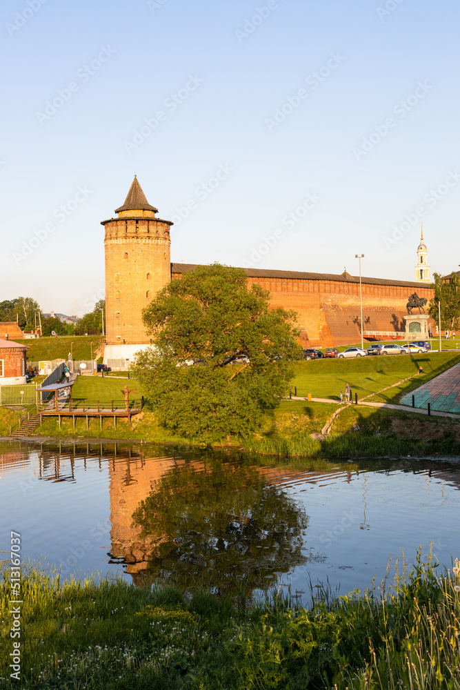view of Marinkina tower and wall of ancient Kolomna Kremlin across Kolomenka river in Old Kolomna city at summer sunset