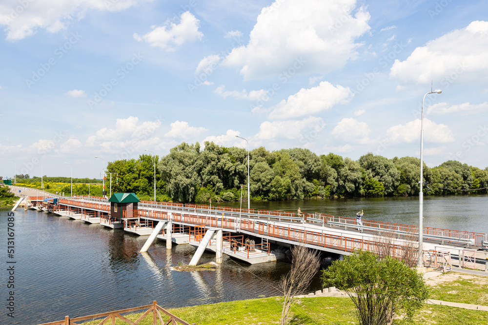 Bobrenevsky pedestrian movable pontoon bridge on Moskva River in Kolomna city on sunny summer day Bobrenevsky pedestrian movable pontoon bridge on Moskva River in Kolomna city on sunny summer day