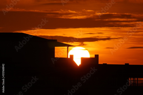 Sunrise viewed through attap house