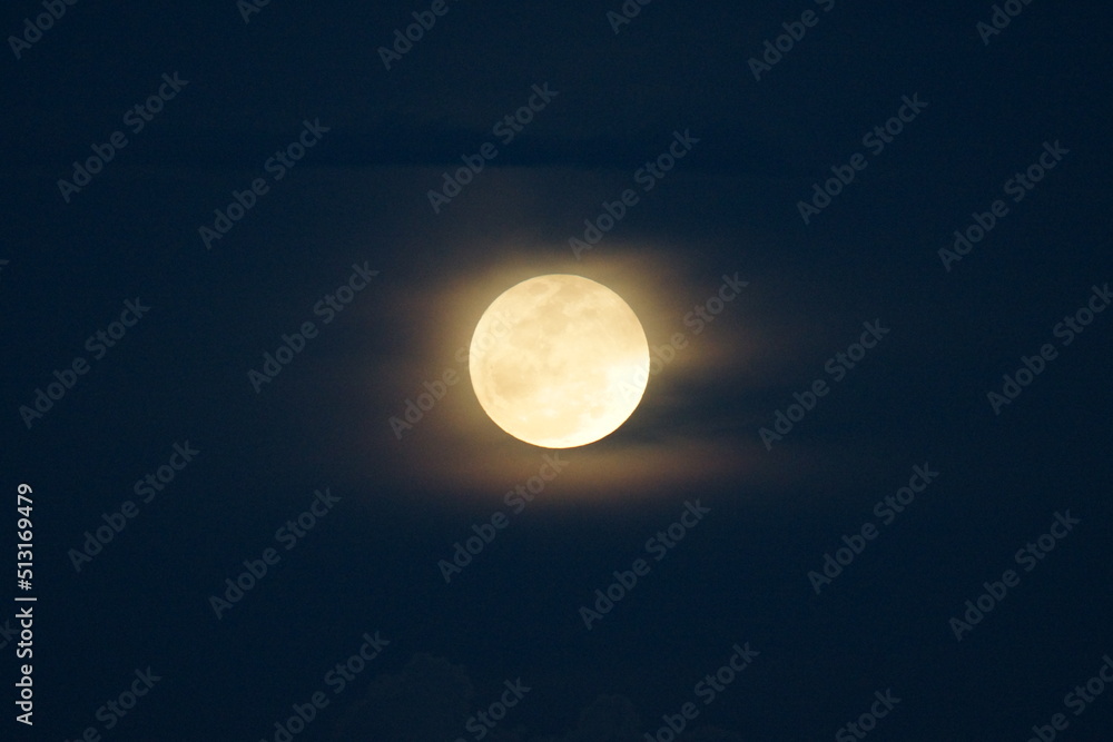 Super Strawberry moon rising on the blue sky Super Strawberry moon rising on the blue sky