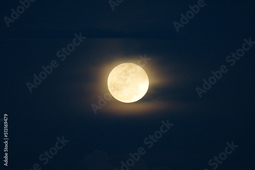 Super Strawberry moon rising on the blue sky 