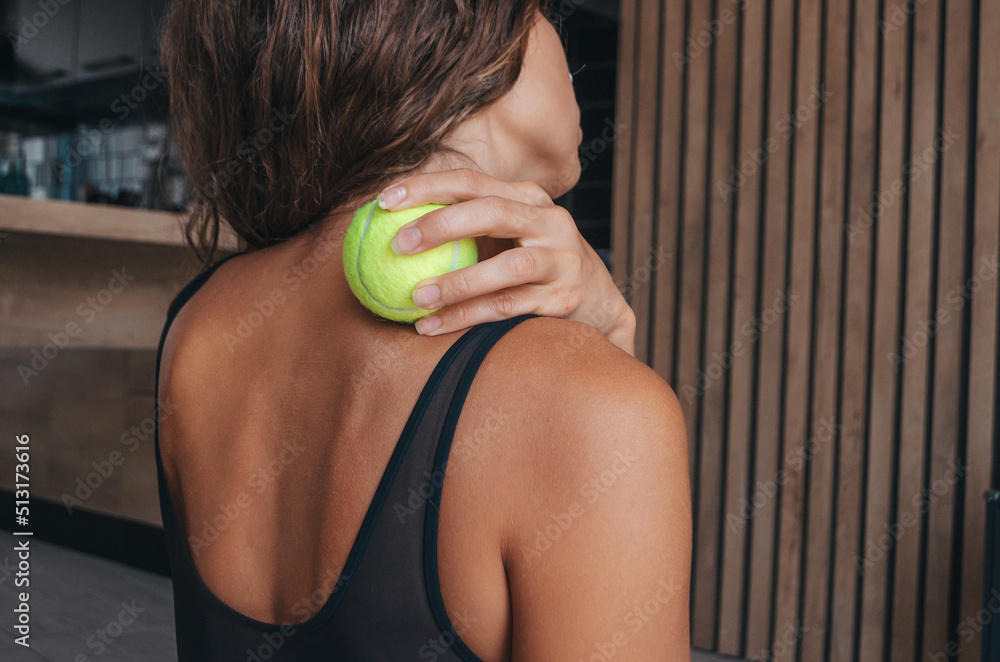 Woman doing self-massage with tennis ball. Myofascial release Stock Photo |  Adobe Stock