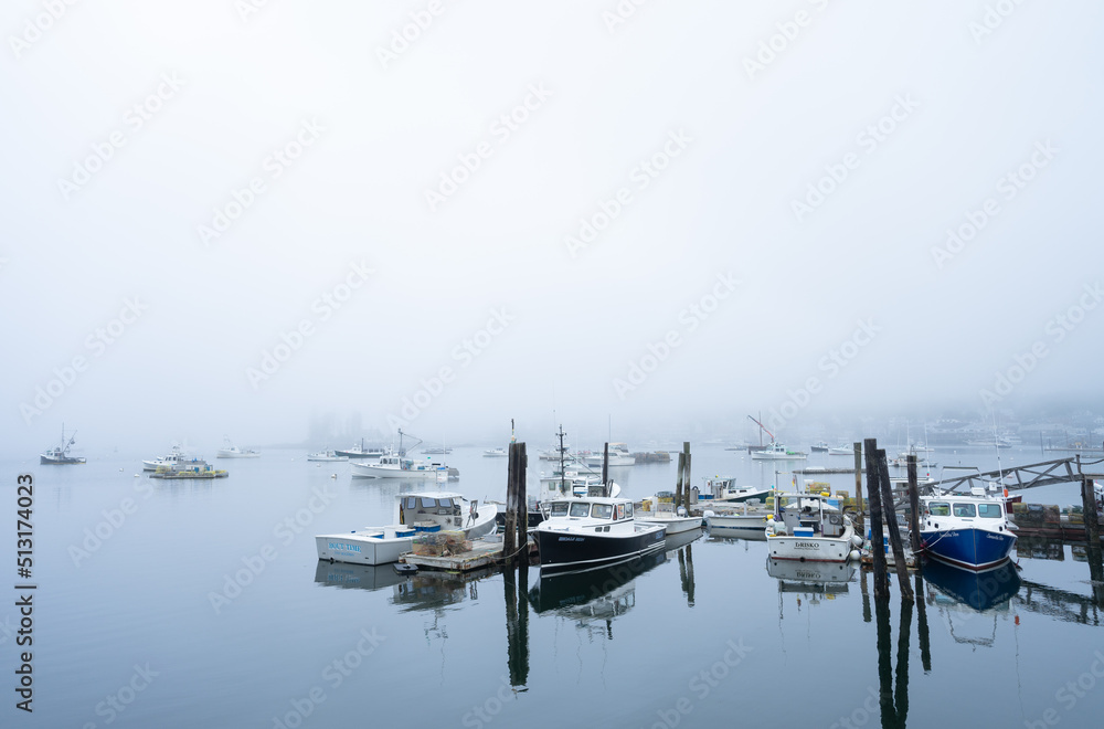 boats in the harbor on a foggy day