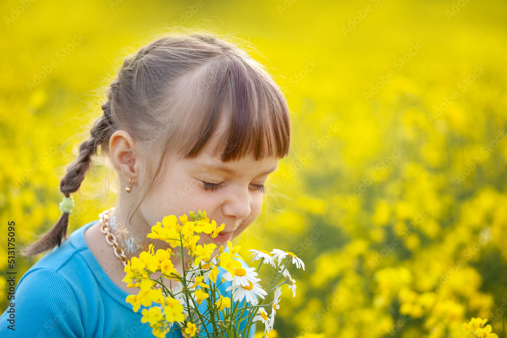 Smiling Little kid girl holding bouquet of fields yellow flowers and chamomiles enjoying summer day. Child giving flowers Smiling Little kid girl holding bouquet of fields yellow flowers and chamomiles enjoying summer day. Child giving flowers