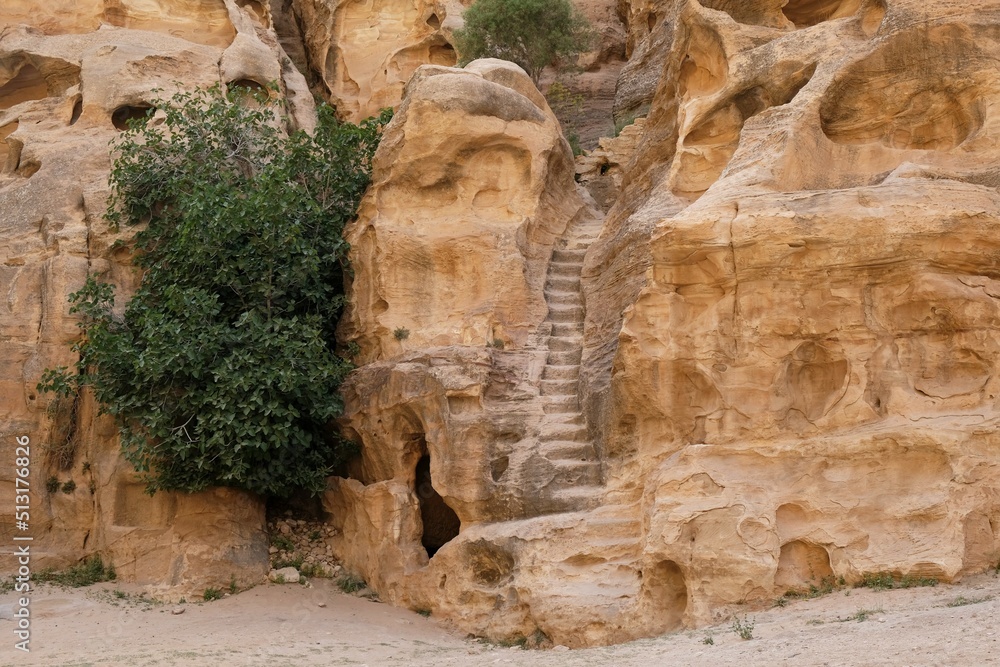 Little Petra (Siq al-Barid), Jordan - circa May 2022: Stone stairs in ancient town Little Petra