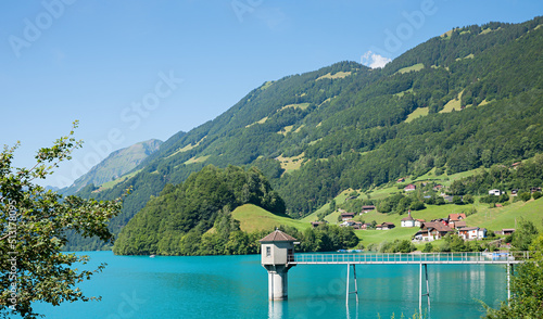 turquoise artificial lake Lungerersee, canton Obwalden, with observation water tower. switzerland photo