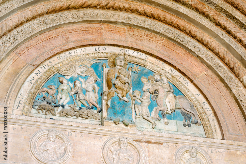 Verona, Italy - lunette decorated with polychrome reliefs depicting the Madonna enthroned with Child; entrance portal of the cathedral of Santa Maria Assunta