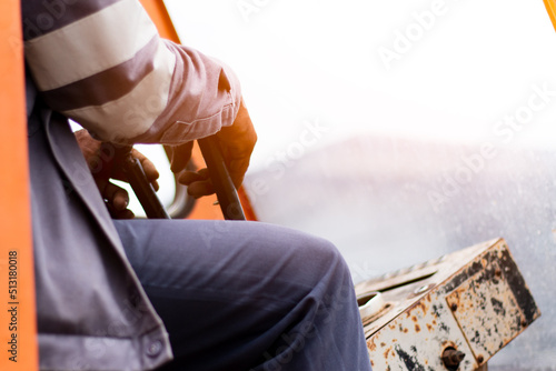 Crane Operator. A worker hand with Lorry Crane control.out door.