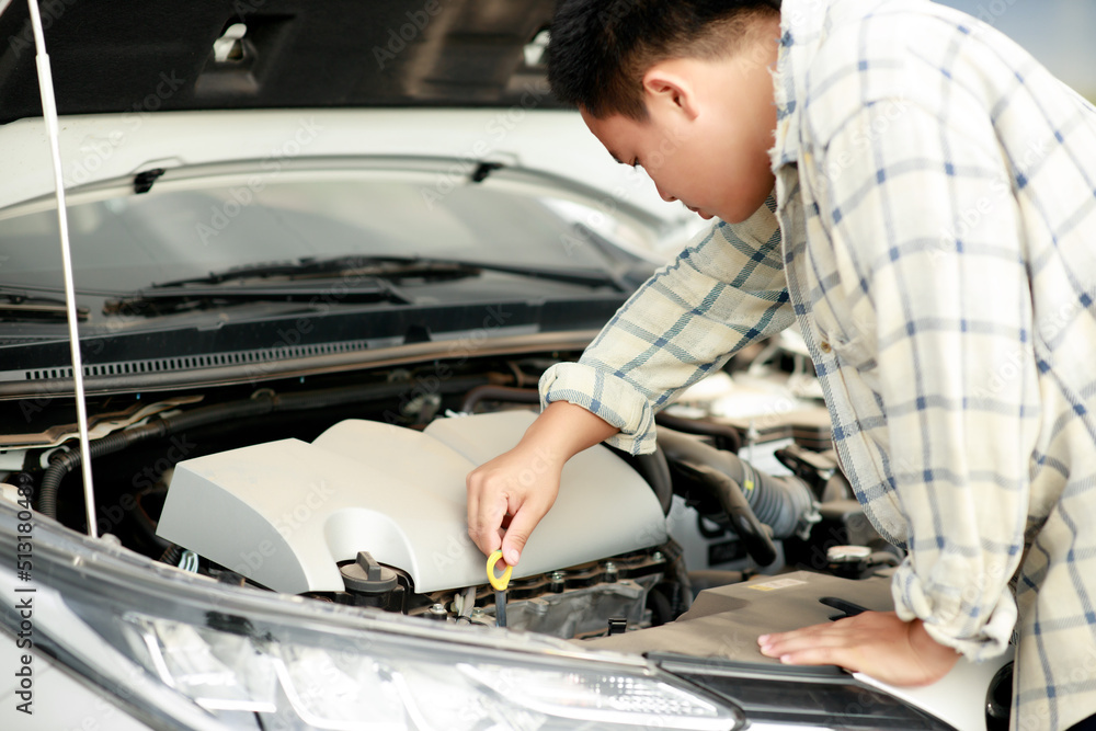 Close up of hand Asian man checking oil level in car engine on the road, Broken car, Repair service, Car inspection center, Insurance car concept. Close up of hand Asian man checking oil level in car engine on the road, Broken car, Repair service, Car inspection center, Insurance car concept.
