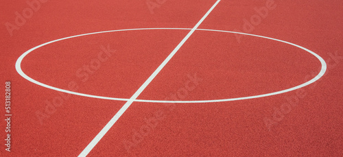 Sports court background. Top view to red artificial rubber ground with central circle field line with copy space