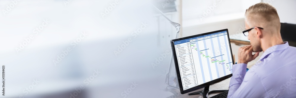 Businessman Analyzing Gantt Chart On Computer Businessman Analyzing Gantt Chart On Computer