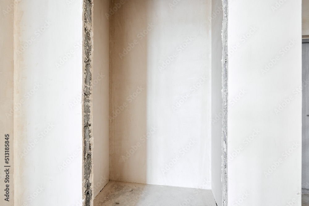 Interior of new apartment without finishing in gray tones Interior of new apartment without finishing in gray tones