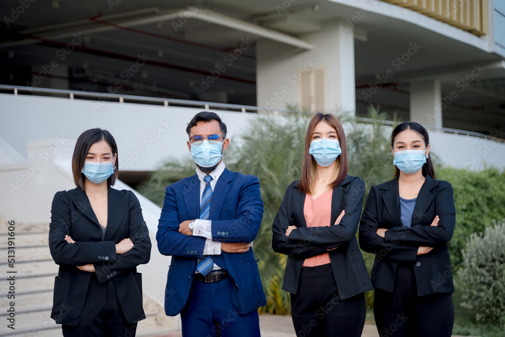 a group of business people wearing protective masks working as a team a group of business people wearing protective masks working as a team
