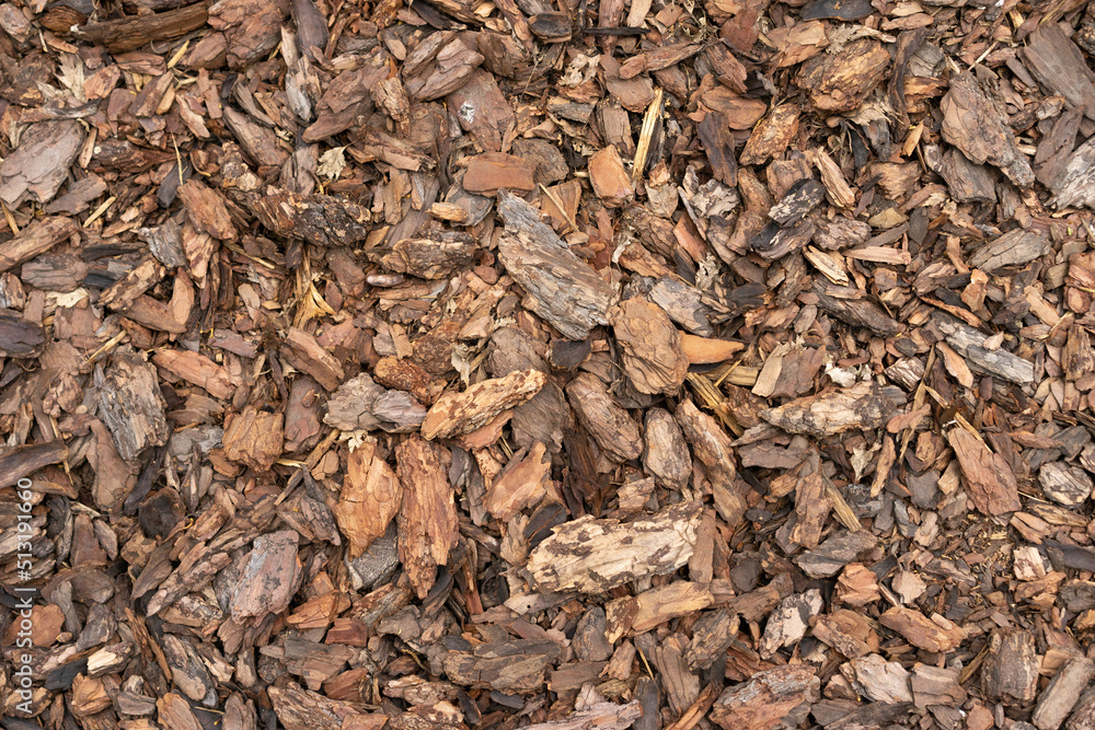 Pine Bark Mulch. A pile of wood chips to be used as landscaping mulch Pine Bark Mulch. A pile of wood chips to be used as landscaping mulch