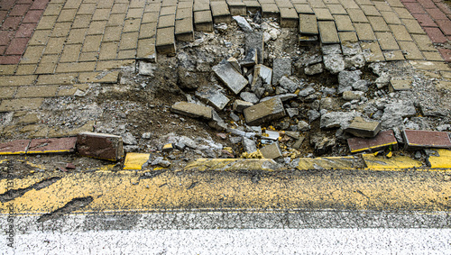 BUCHA, UKRAINE - June 20, 2022: crater funnel from a snard explosion at a crosswalk, sidewalk, asphalt