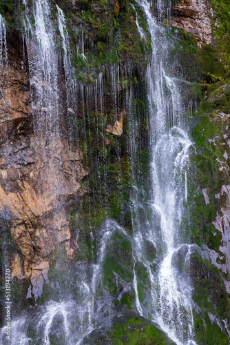 Mountain waterfall. Travel concept with family and friends.