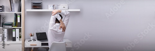 Businessman Stretching His Arms © Andrey Popov