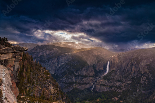 Light rays shimmer over Yosemite Falls seen from the Glacier Point overlook