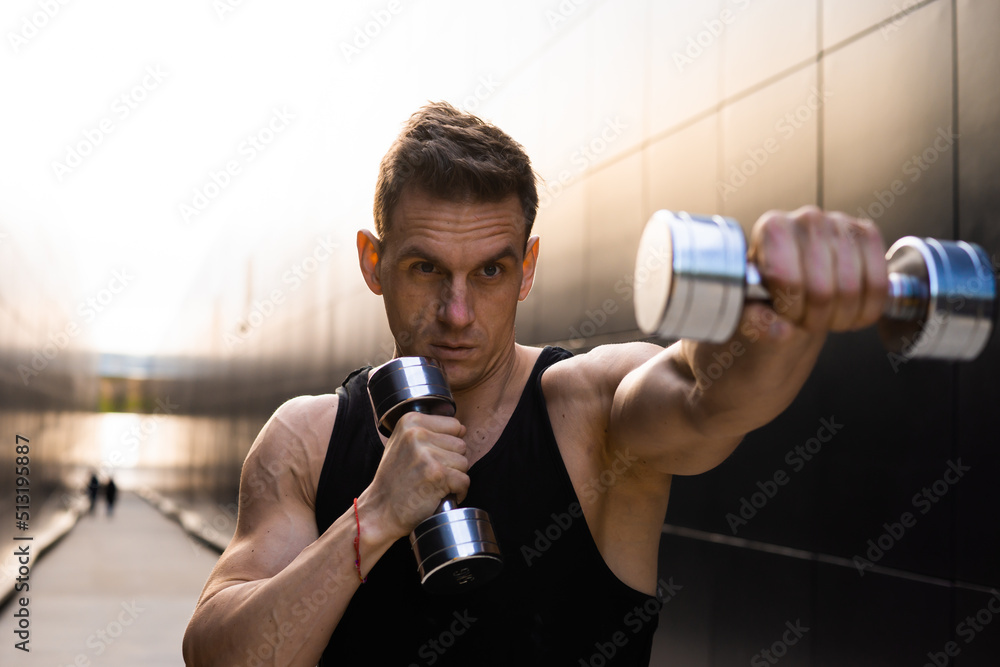 Young Muscular Man Doing Sports Outside at Sunset. Training of a Young Strong Athlete. Fitness and Healthy Lifestyle Concept. Young Muscular Man Doing Sports Outside at Sunset. Training of a Young Strong Athlete. Fitness and Healthy Lifestyle Concept.