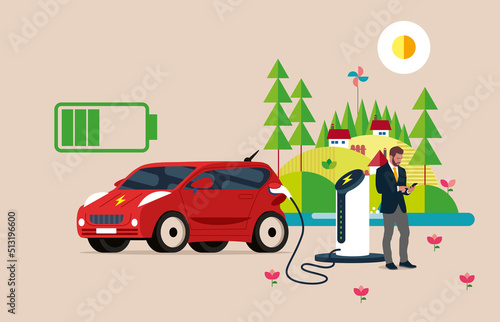 Handsome businessman plays smartphone while waiting for his EV Car or Electric charging at the charger station with the power cable supply plugged in.