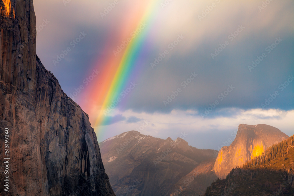Rainbow over Yosemite seen from the Tunnel Overlook in Yosemite National Park.  Seen are El Capitan and Half Dome.