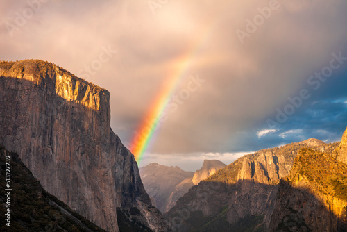 Rainbow over Yosemite seen from the Tunnel Overlook in Yosemite National Park. Seen are El Capitan and Half Dome.