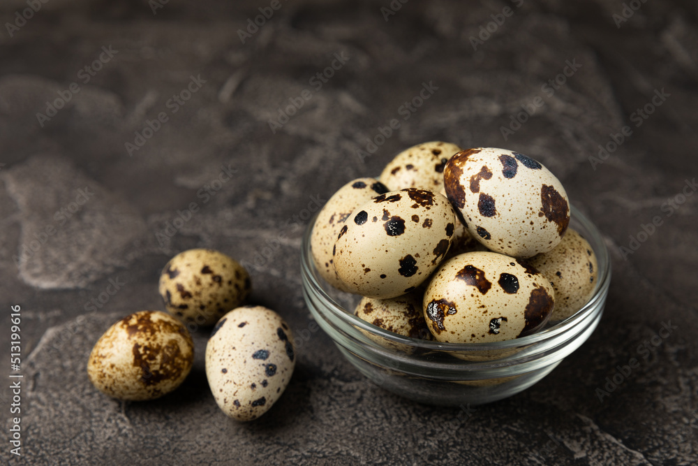 Quail eggs in a bowl on a black texture background. Natural products. Place for text. fresh eggs Quail eggs in a bowl on a black texture background. Natural products. Place for text. fresh eggs