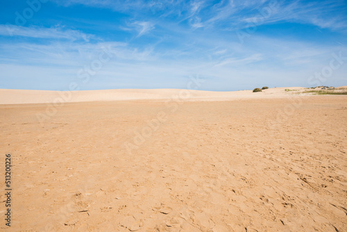 background sandy dunes and blue sky with cirrus clouds