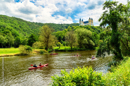 Obernhof at the Lahn with Kloster Arnstein on the hill . Beautyful landscape with river and boats in the Lahn valley on a sunny day in summer.