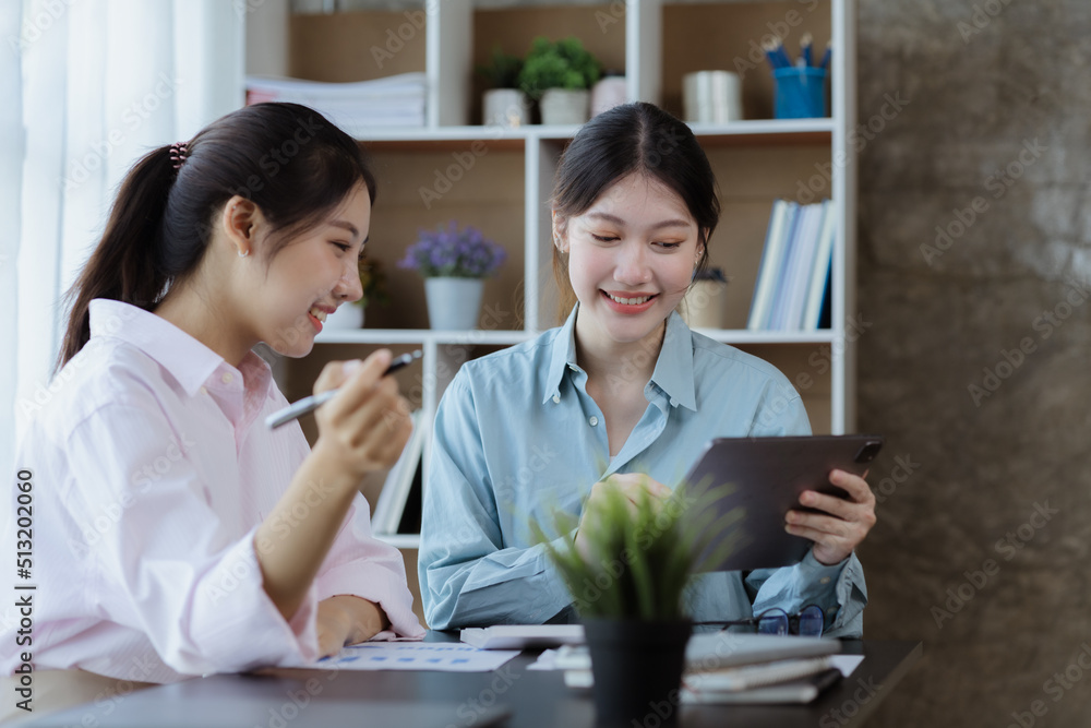 Beautiful Asian woman chatting with colleague in company office, businesswoman operating company administration, staff working as a team in department for planning meeting. Working women concept. Beautiful Asian woman chatting with colleague in company office, businesswoman operating company administration, staff working as a team in department for planning meeting. Working women concept.