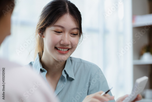 Close up beautiful Asian woman chatting with colleagues in company office, businesswoman operating company administration, staff working as a team in department. Working women concept.